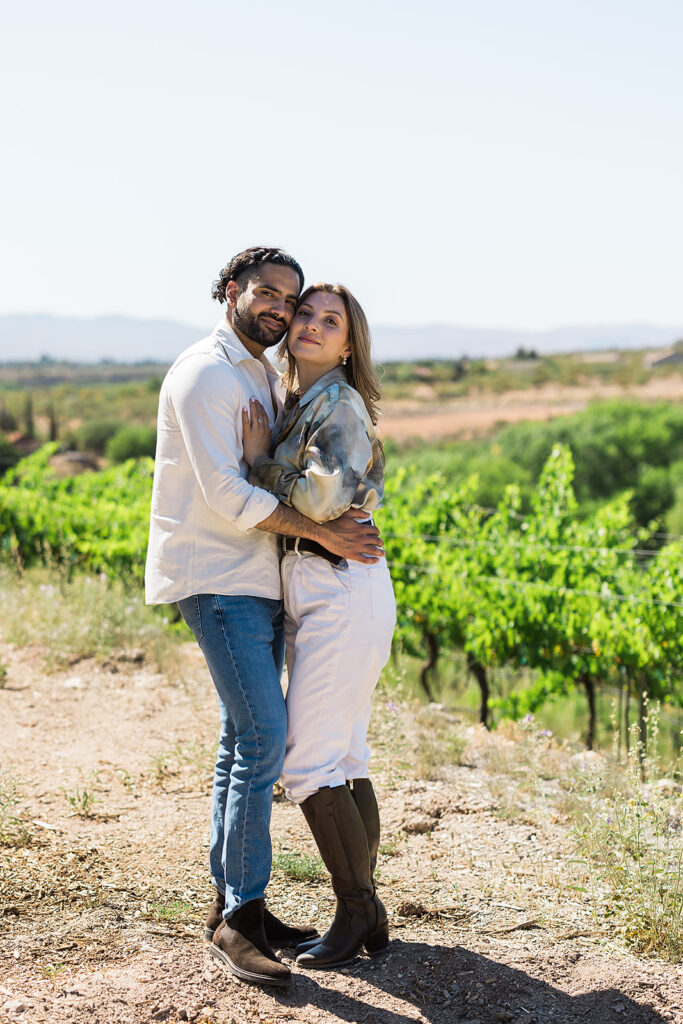 bride and groom embracing in vineyard