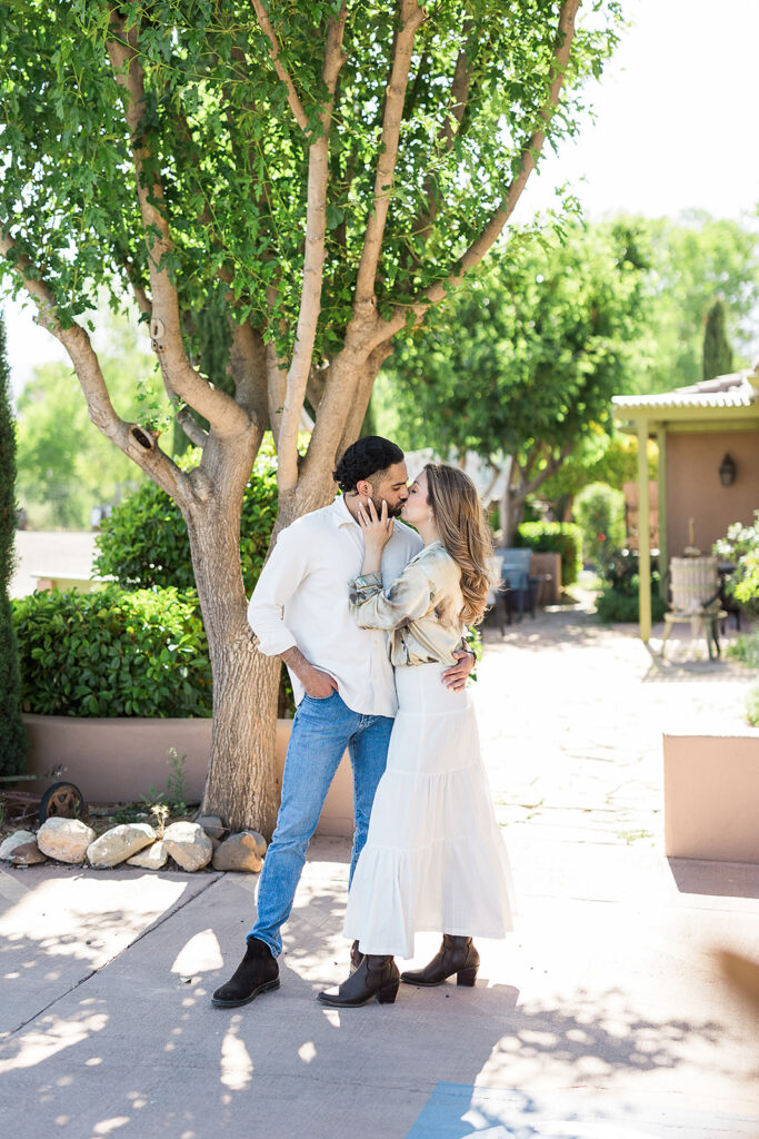 bride and groom embracing outside vineyard