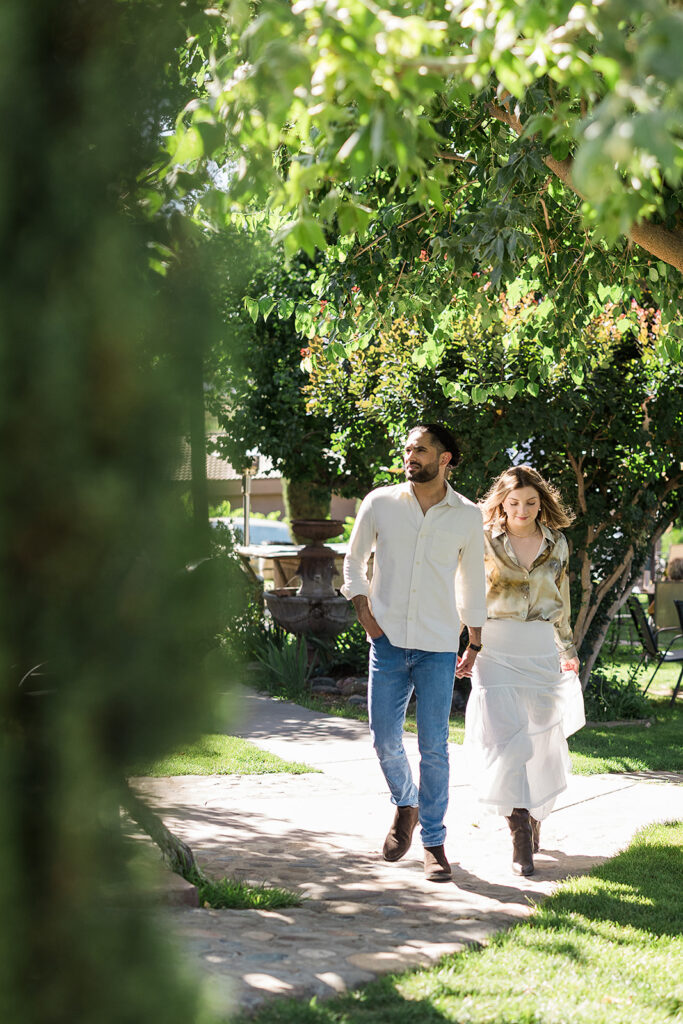 bride and groom embracing during walking in vineyard
