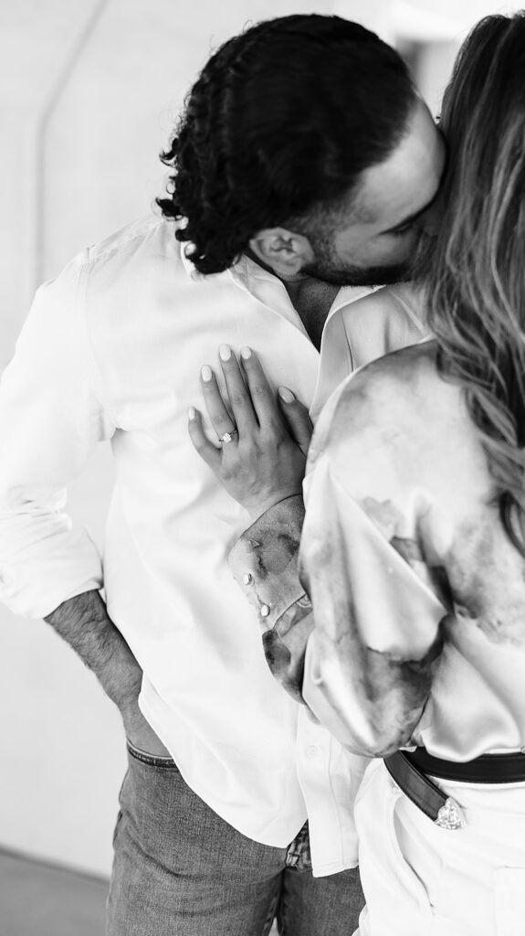 groom kissing bride's neck during proposal