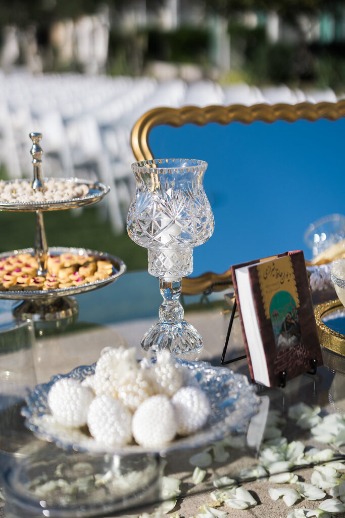 Elegant sofreh aghd with sweets and mirror.