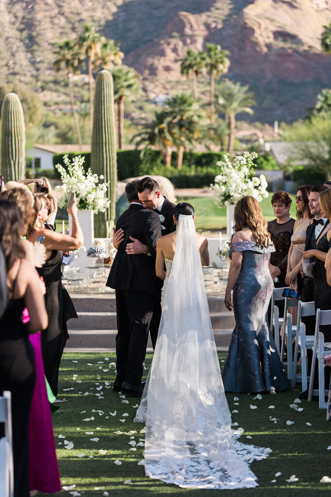 groom hugs bride's father at aisle at mountain shadows wedding