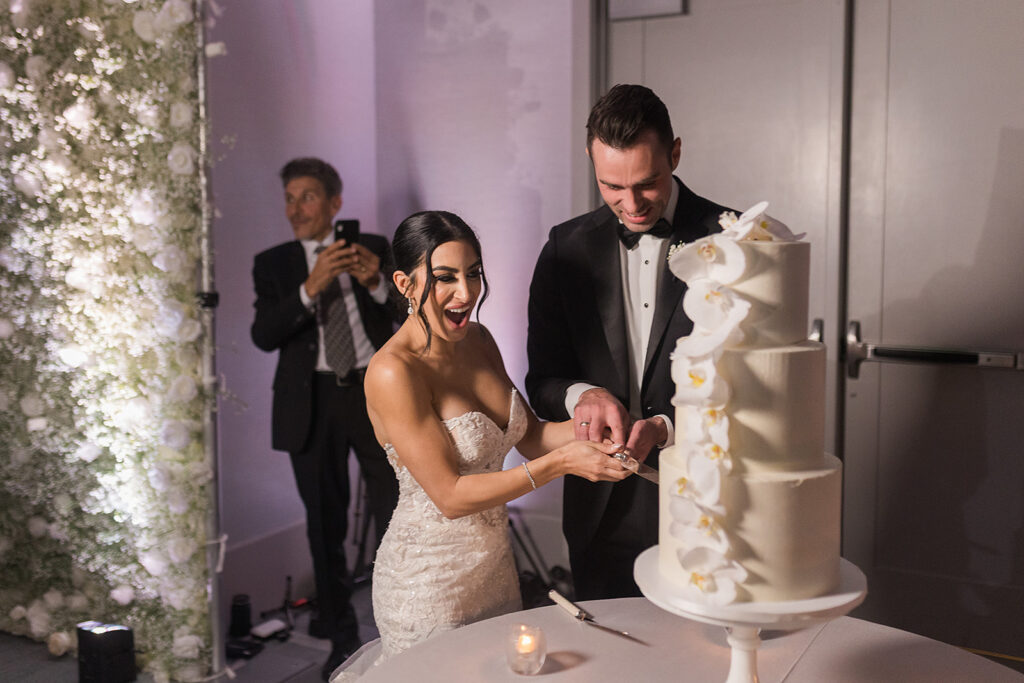 bride and groom cut cake at wedding
