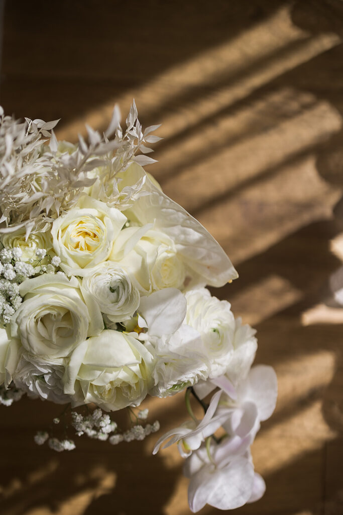 bridal boquet and perfume on table in hotel room