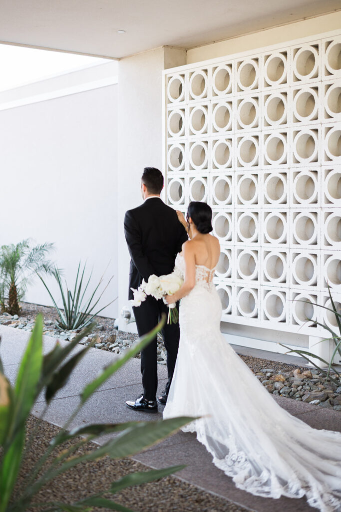 groom with his back to bride for a first look at mountain shadows