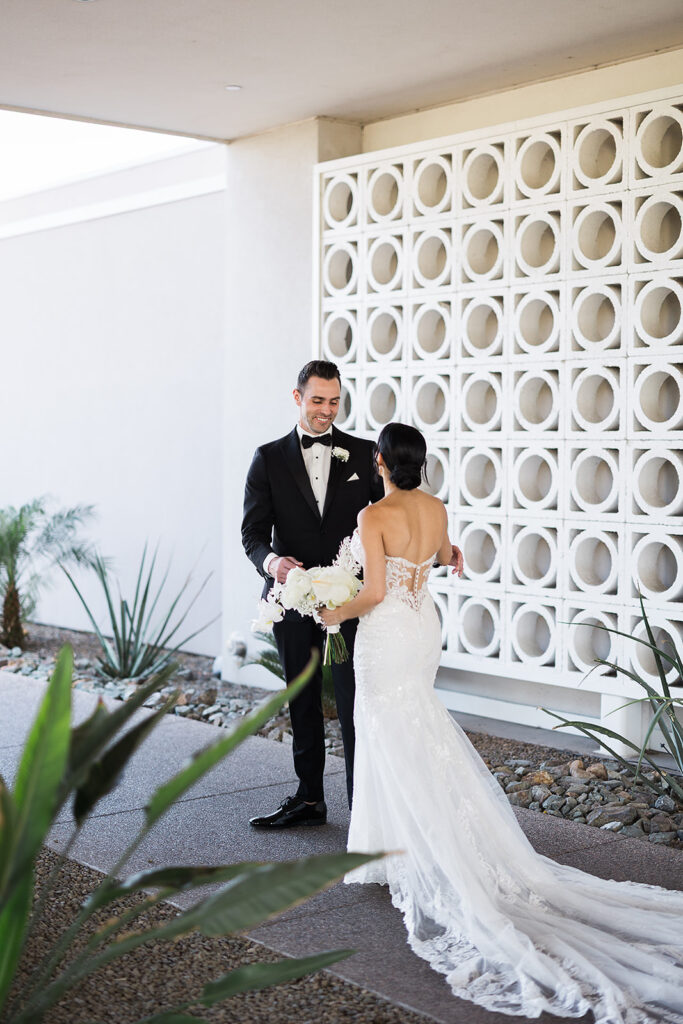 groom reacts with surprise at bride during first look