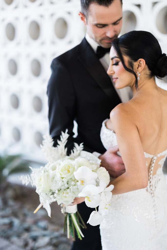 bride and groom embracing for portraits