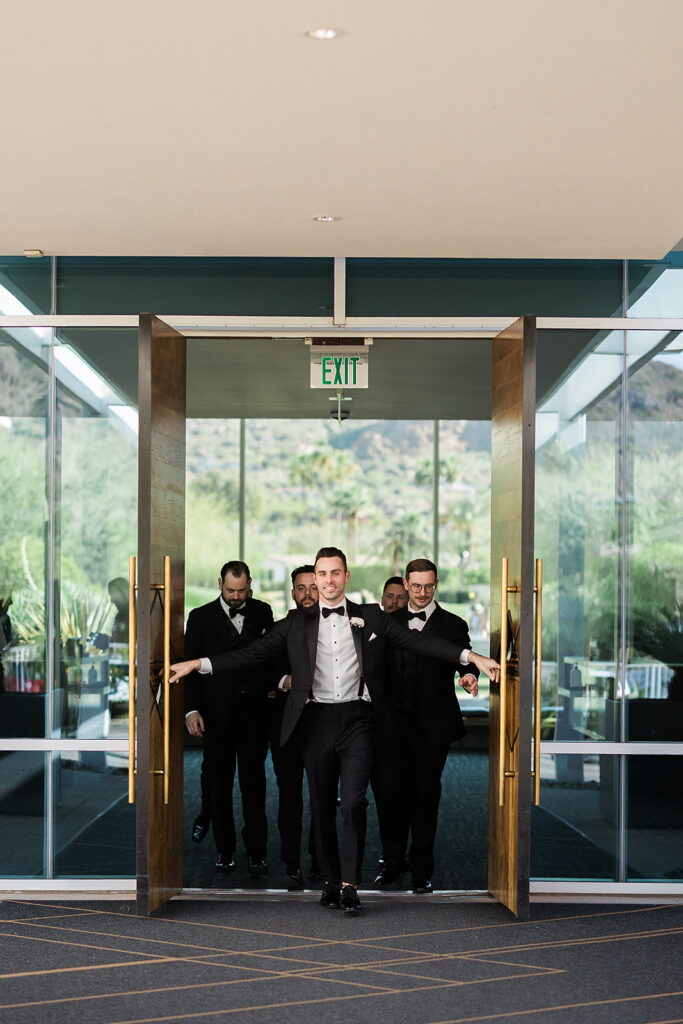groom leading groomsmen out front door of mountain shadows resort